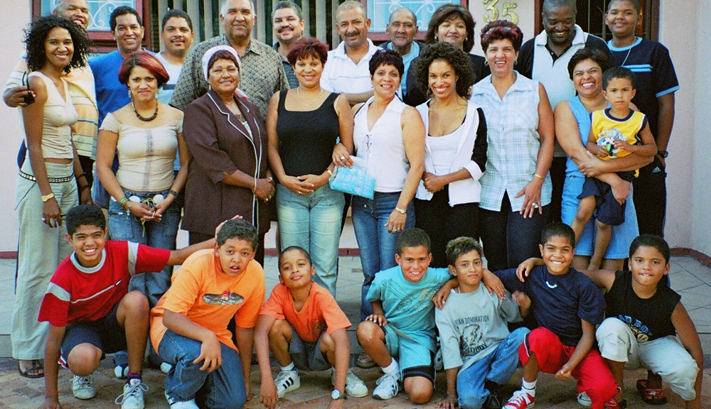 This is a photo of an extended Coloured family with roots in Cape Town, Kimberley, and Pretoria (South Africa). The photo was taken in Thornton, Cape Town at Christmas 2000. The picture was taken by Henry Trotter, to whom these family members are in-laws. They comprise the Binghams, the Abrahams, the Bayards, and the Fortunes. The author releases the picture to the public domain.